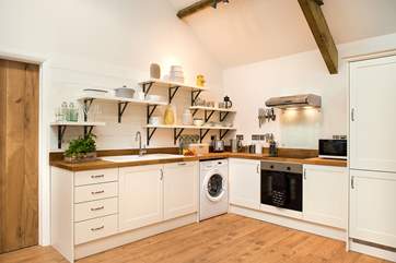 The delightful kitchen area is very well-equipped.