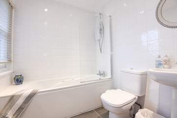 The first floor family bathroom with bath and fitted shower.