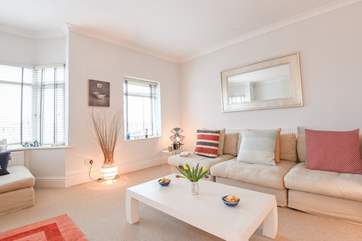 This bright and airy sitting-room has plenty of space and cosy seating for all.