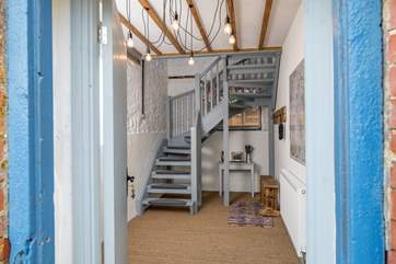 Step into the entrance hall, kick off your boots and make your way up the stairs.