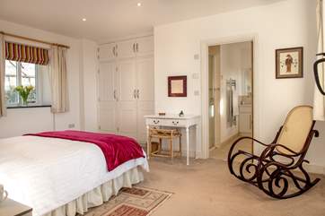 The bedroom is very spacious with plenty of storage space.