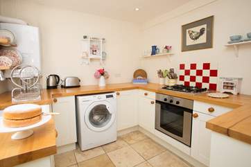 The stylish kitchen is very well-equipped....