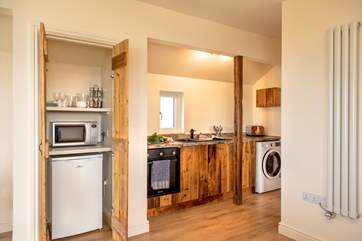 The kitchen has a hidden cupboard full of equipment.