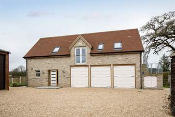 The front door is to the left, the garages beneath are only used for storage and will not be accessed during your holiday.