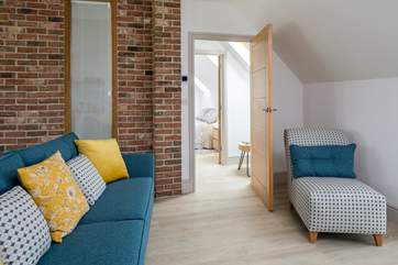 View from the open plan living-room, through to bedroom 2, the stairs are through the door on the left.