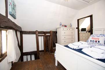 One bedroom is open to the stairs but has a door at the bottom for privacy.