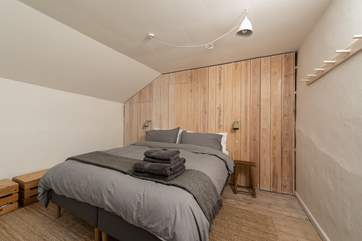 This bedroom has very clever hidden storage space in the wall panelling.