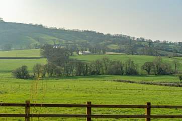 This is the lovely setting for the cottage. The farm nestles into the hillside - the woodland at the top is managed by the National Trust and the Woodland Trust.