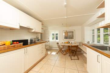 The kitchen offers plenty of space and a door at the far end leads into the sitting-room - as well as another door from the hallway.