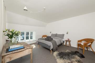 The three bedrooms are all on the first floor. This is the main bedroom. All the rooms are just as stylish and have a calm feel to them.