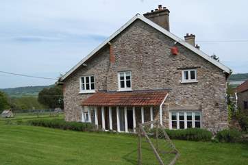 This is a view of Whitehall Farm Cottage from the top of its large garden. There is plenty of space for children to play and the garden is fenced.