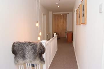 The first floor corridor has a cosy reading area at the far end with a floor to ceiling bookshelf to choose holiday reading from.