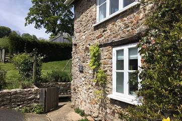 There is plenty of parking outside the cottage. The path to the front door runs around the side of the building.