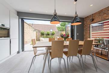 The open plan kitchen/dining-room with the light pouring in from the garden.