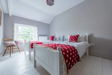 The twin bedroom on the second floor looks out to the front of the house