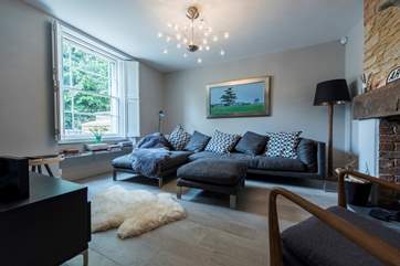 The living-room looks out to the front of the house - with its original sash windows and shutters.