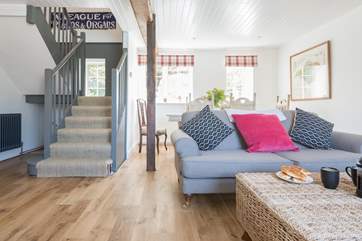The open plan living-room with dining-table overlooking the front gardens.