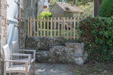 Stone steps lead from the parking-area to the main entrance.