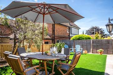 The rear enclosed garden has astro turf.