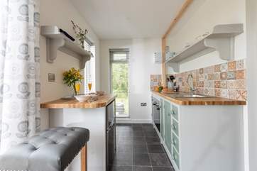 The kitchen area is well-equipped with all you could need for a comfortable stay.