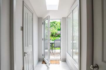 Step outside into the enchanting garden, with a door leading to the utility-room containing the washer, tumble-drier and sink. There is also a downstairs cloakroom.