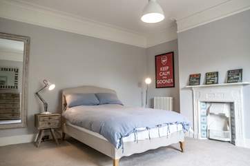With a reclaimed ornamental fireplace, the bedroom is a relaxing haven.