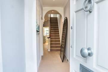 The elegant hallway leads to the staircase.