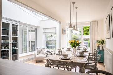 The open plan living-room with kitchen and dining areas are light and spacious.