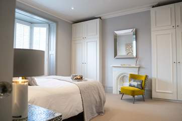 The master bedroom is spacious and has plenty of storage.