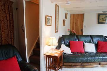 A typical cottage staircase leads from the sitting-room to the first floor bedrooms and bathroom.