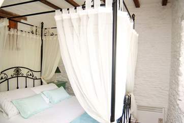 A four-poster adds charm to the bedroom.