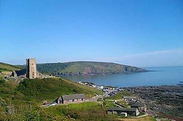 The tower of Wembury church and the coast beyond.