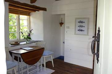 The dining area leads down towards the bedroom.