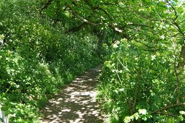 The footpath leads uphill from the village to the car park.