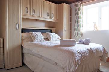 Bedroom 1 has a double bed and plenty of built-in storage.