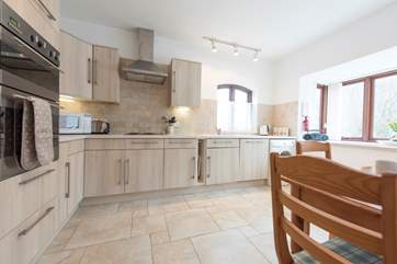 The spacious kitchen is fully equipped with a ceramic electric hob.