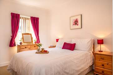 The master bedroom has crisp white linens.