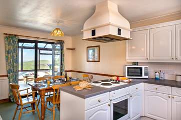 The light and airy kitchen diner which leads through to the conservatory
