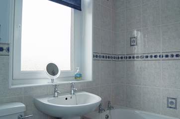The bathroom is at the end of the hallway next to Bedroom 2.