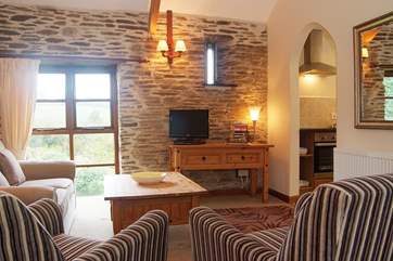 The open plan living-room has an archway leading through to the kitchen-area.