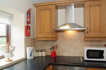 The kitchen is small but well-equipped, with lovely garden views.