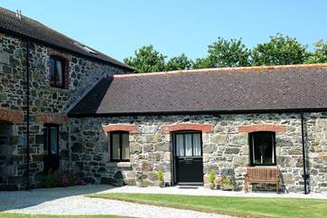 Viewed from across the shared courtyard garden, Kynance nestles quietly between its neighbours.