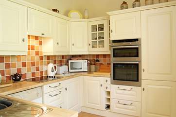 The beautiful kitchen is very well-equipped.