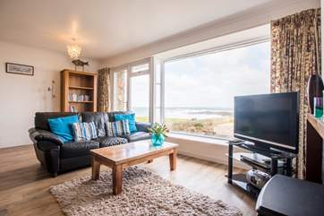 A large TV and comfortable sofas.