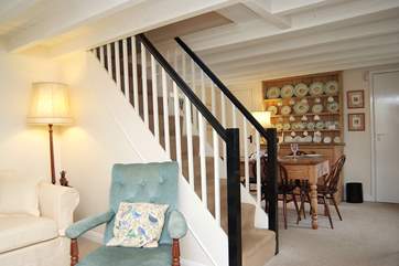 The stairs divide the sitting-area from the dining end of the living-room.